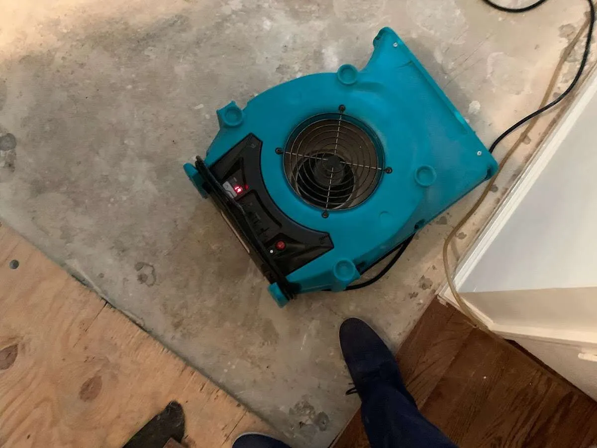 Air mover drying subfloor during Commercial Water Damage Restoration in Santa Ana